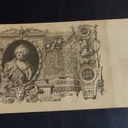 Russia 100/- Note old big size 100 Ruble banknote issued by the Imperial Russian government in 1910. Historical Significance: This banknote represents a piece of Russian history from the era of the Russian Empire, connecting to the events and people of that time. Design: The obverse of the note features the denomination and text indicating its exchangeability for gold at a fixed rate. The double-headed Eagle, a symbol of Russia, is visible at the top-middle. condition as 🖼 Images