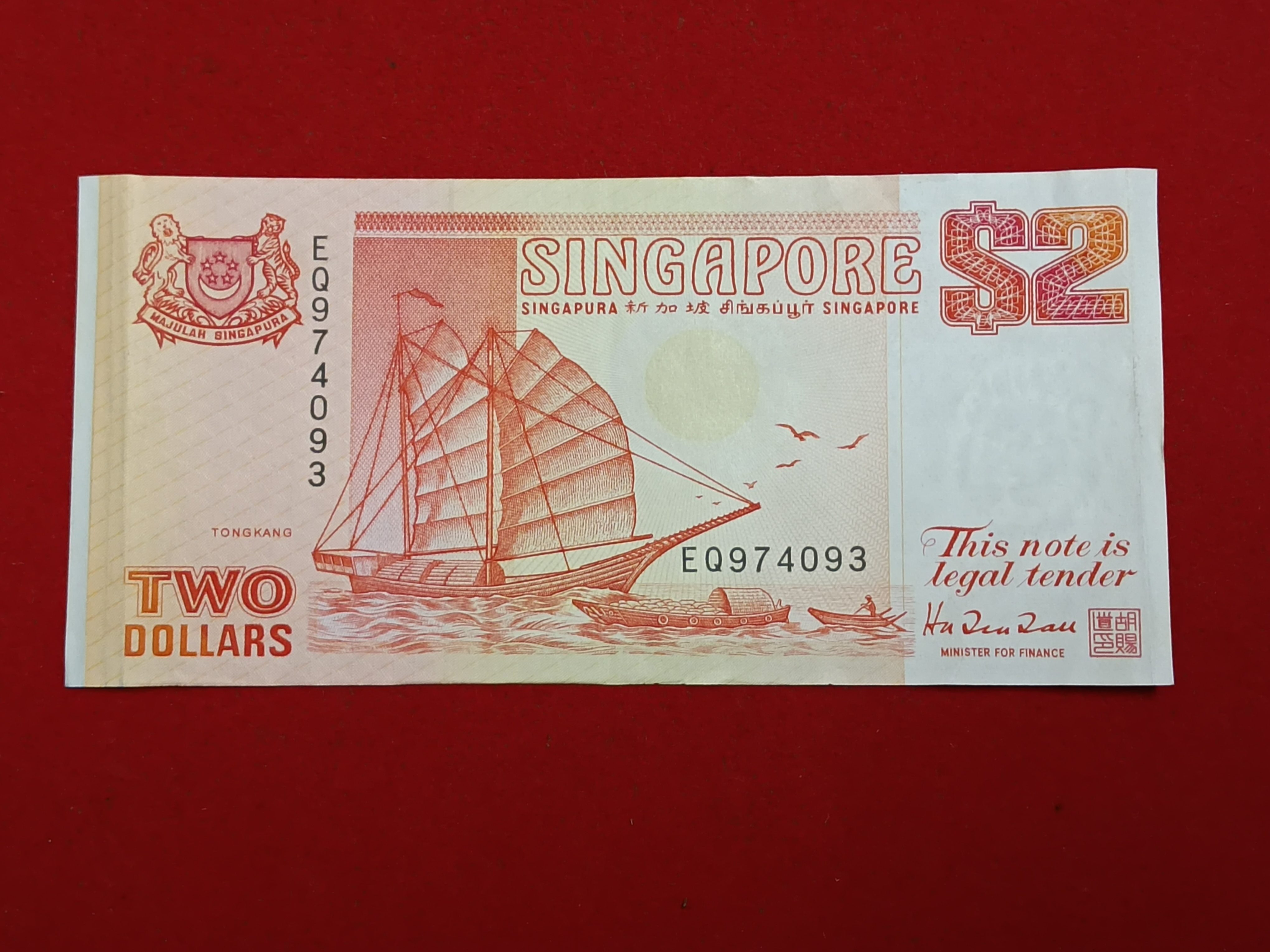 Rare Note Singapore 2 Dollar banknote featuring a traditional tongkang (light wooden boat) from Singapore's Ship Series first issued Gem Unc Condition